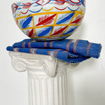 White, blue, red, and yellow dried hollowed gourd serving bowl