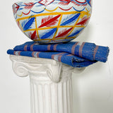 White, blue, red, and yellow dried hollowed gourd serving bowl