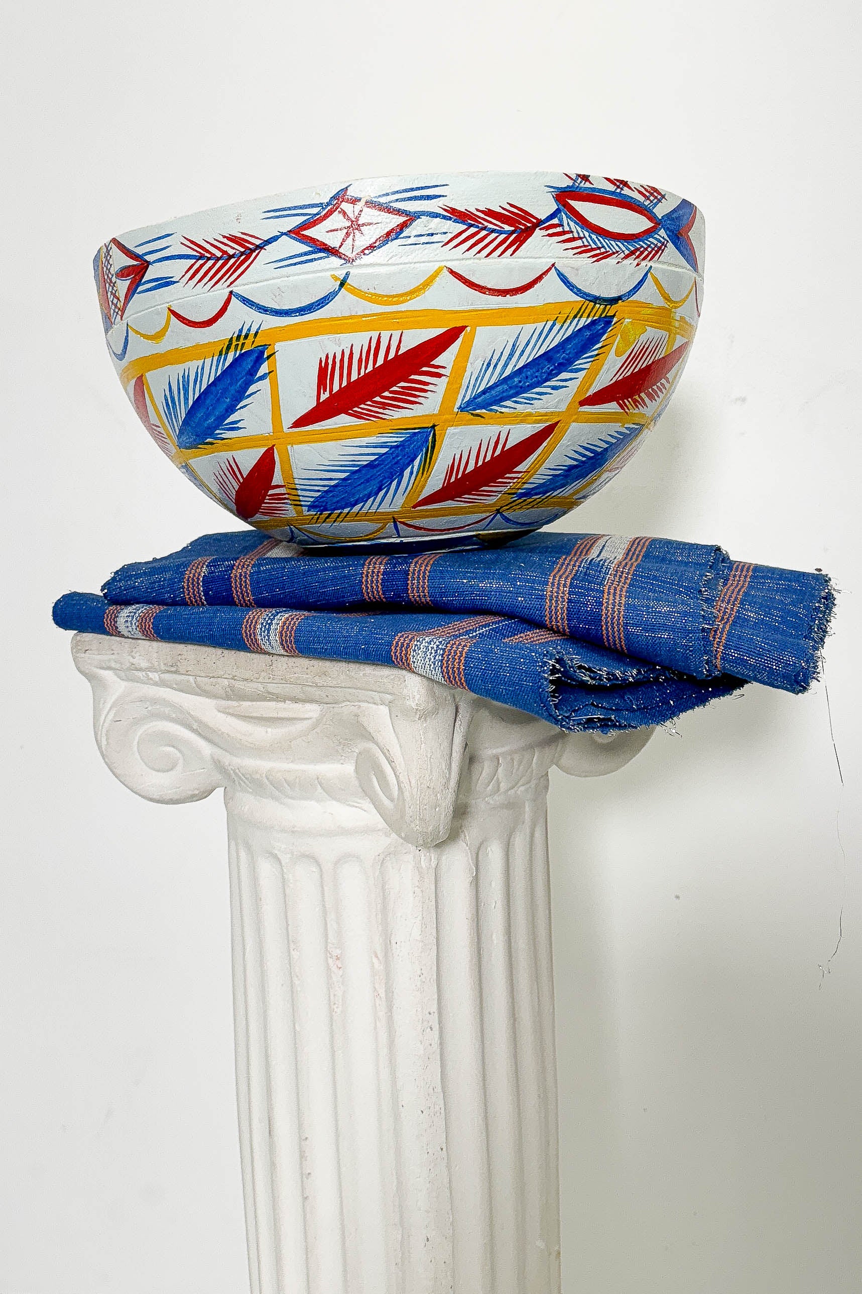 White, blue, red, and yellow dried hollowed gourd serving bowl