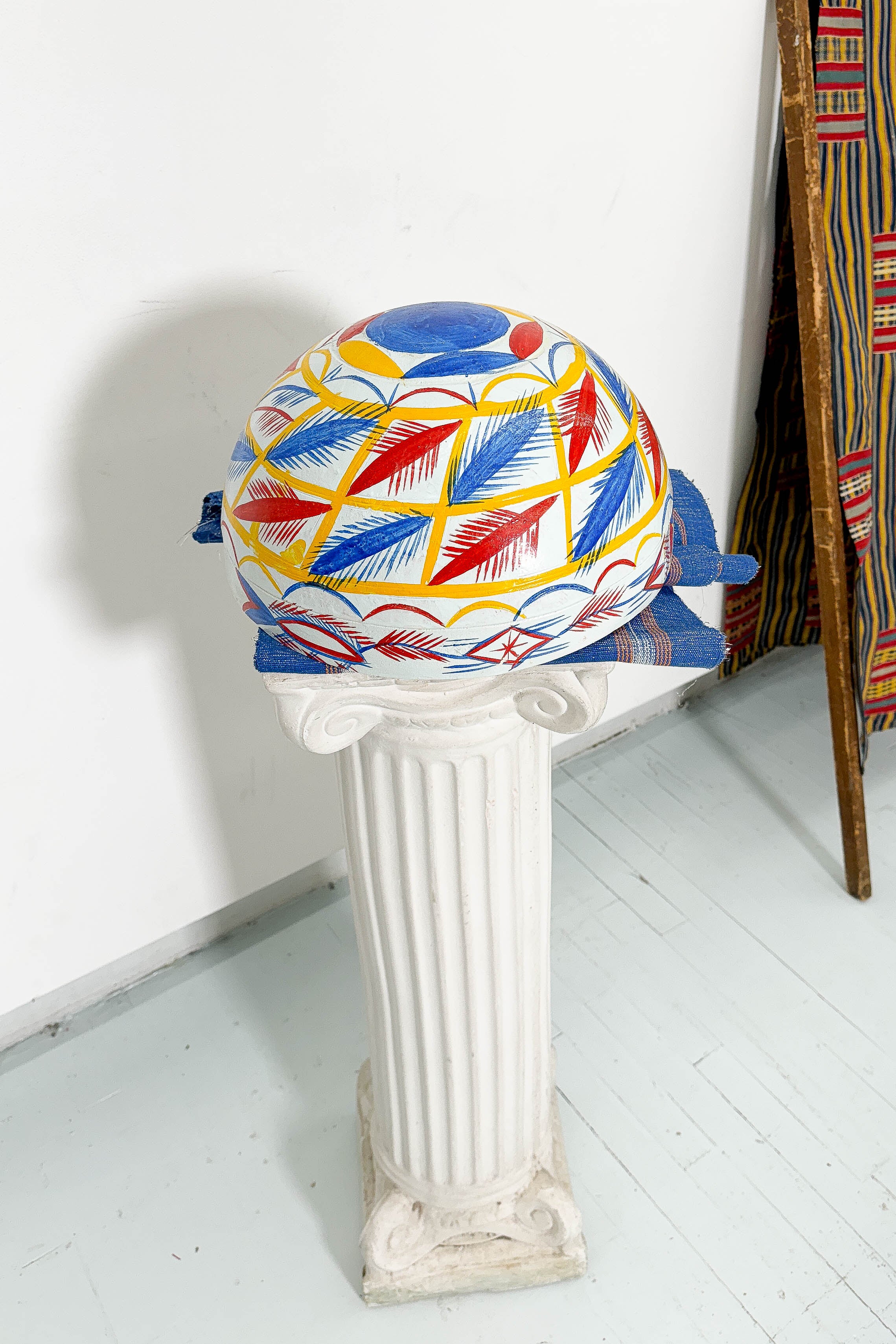 White, blue, red, and yellow dried hollowed gourd serving bowl