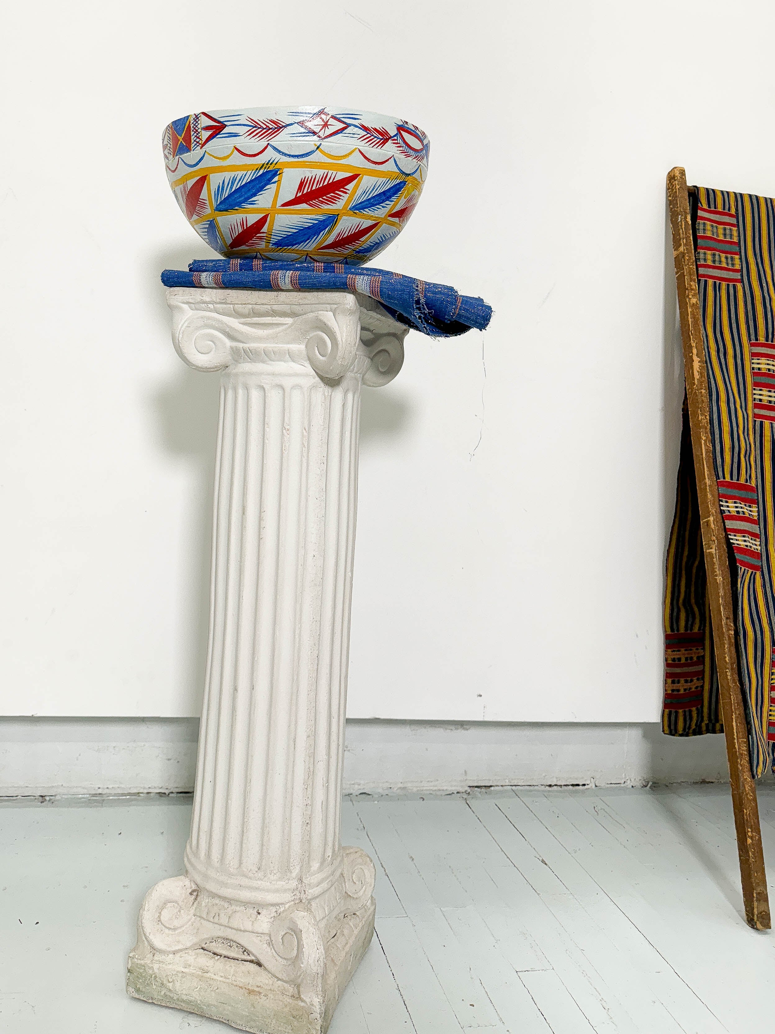 White, blue, red, and yellow dried hollowed gourd serving bowl