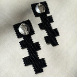 black glass beaded geometric cross earrings