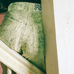white cotton green ink splatter stove pipe jeans