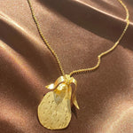 gold etched pear necklace on a dainty chain