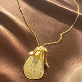 gold etched pear necklace on a dainty chain