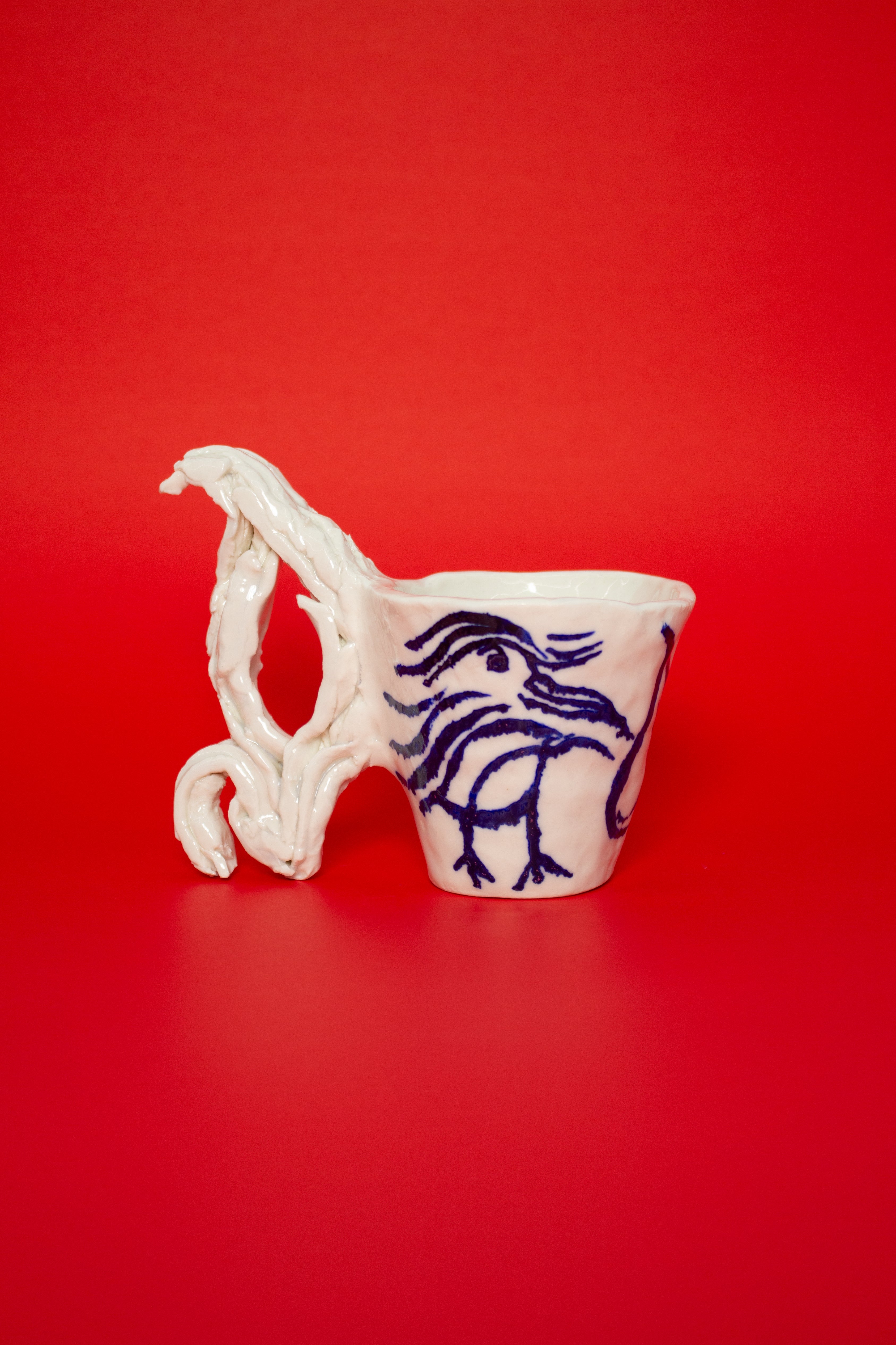 SCULPTURAL CUPS IN PORCELAIN WITH HAND PAINTED BIRDS