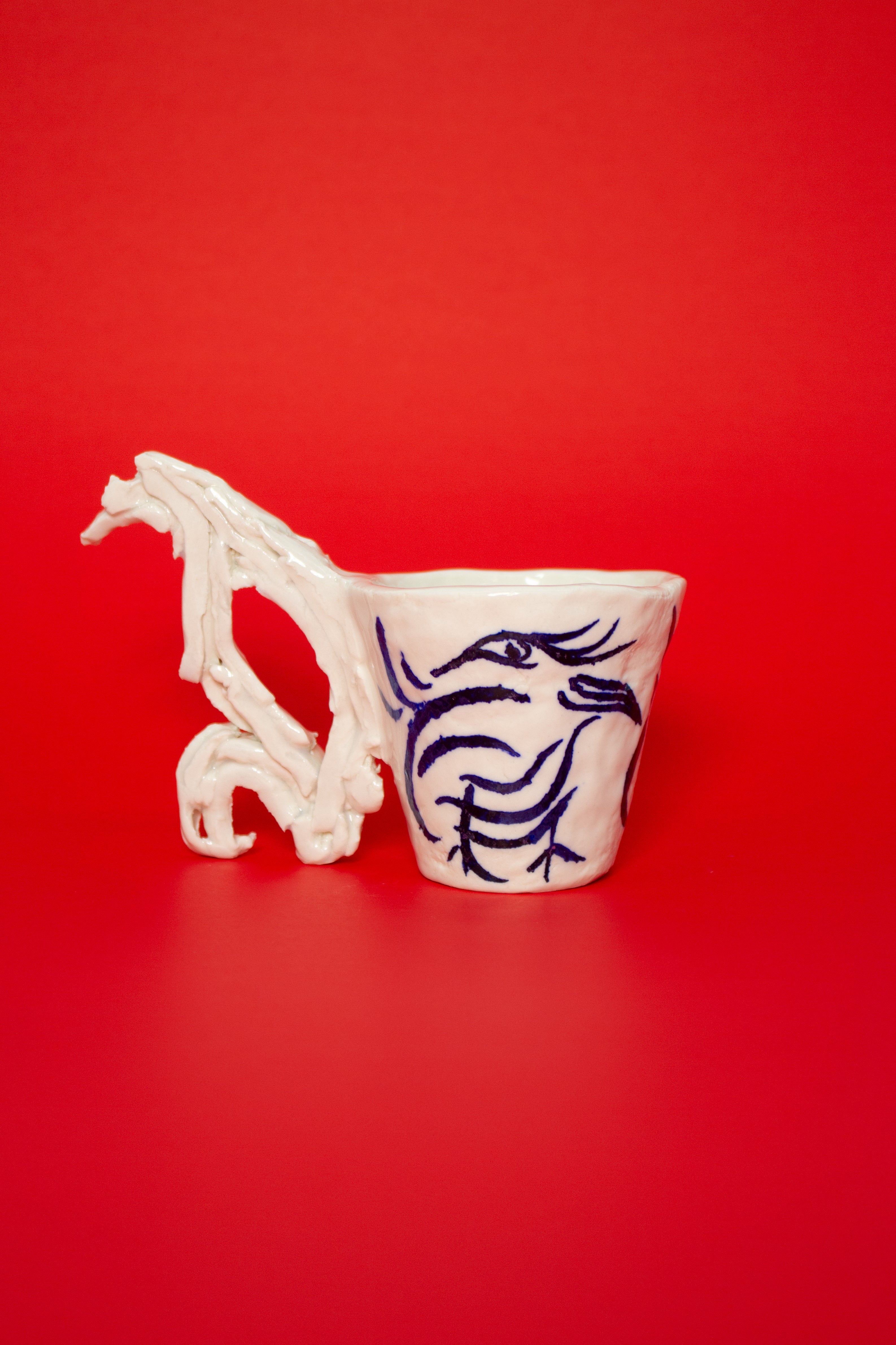 SCULPTURAL CUPS IN PORCELAIN WITH HAND PAINTED BIRDS