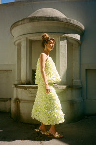 light yellow mid length ruffled skirt