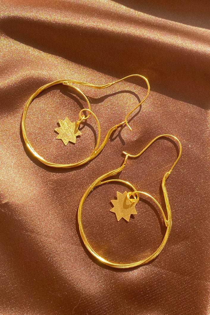 gold dainty hoop earrings with shooting star