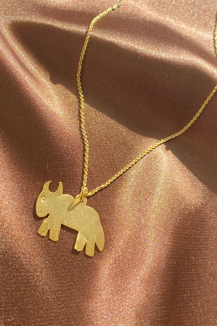 dainty gold goat pendant on a thin chain