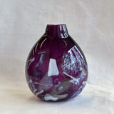 purple handblown glass vase with white patterns
