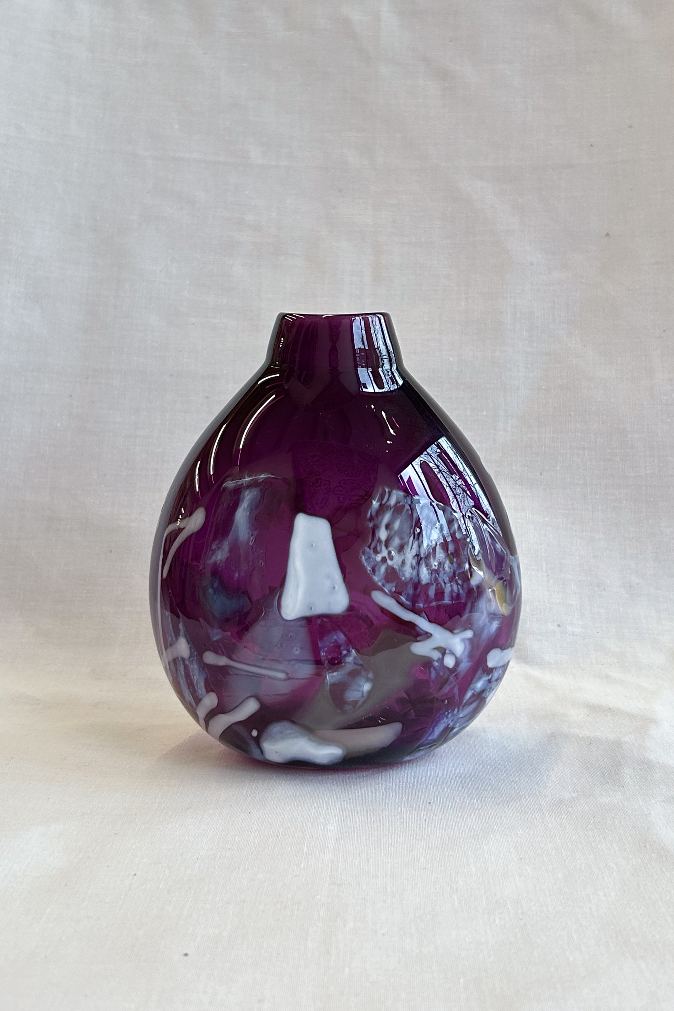 purple handblown glass vase with white patterns