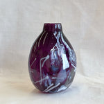 purple handblown glass vase with white patterns