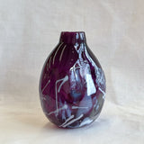 purple handblown glass vase with white patterns