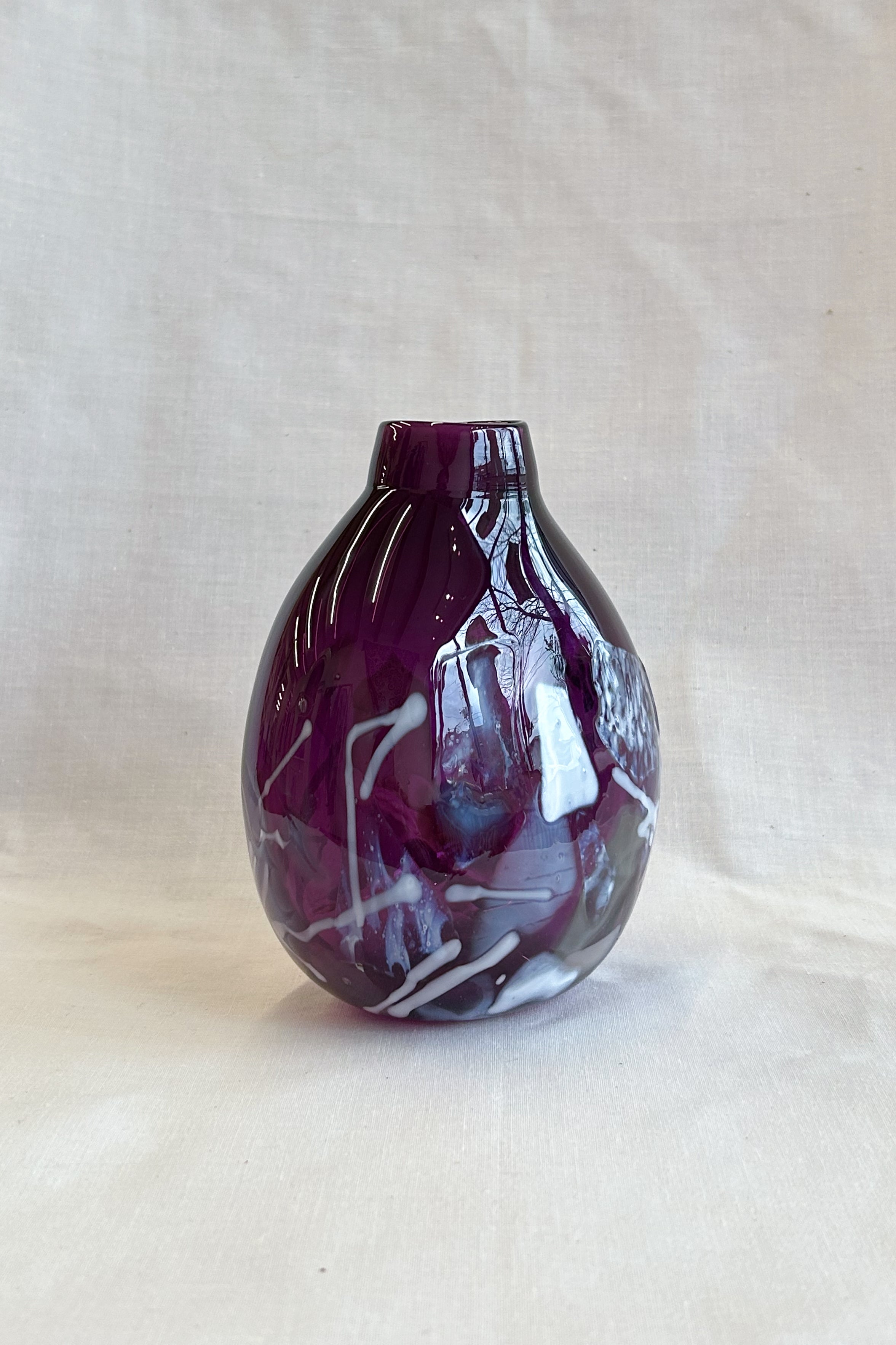 purple handblown glass vase with white patterns