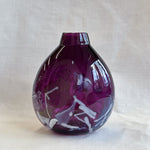 purple handblown glass vase with white patterns