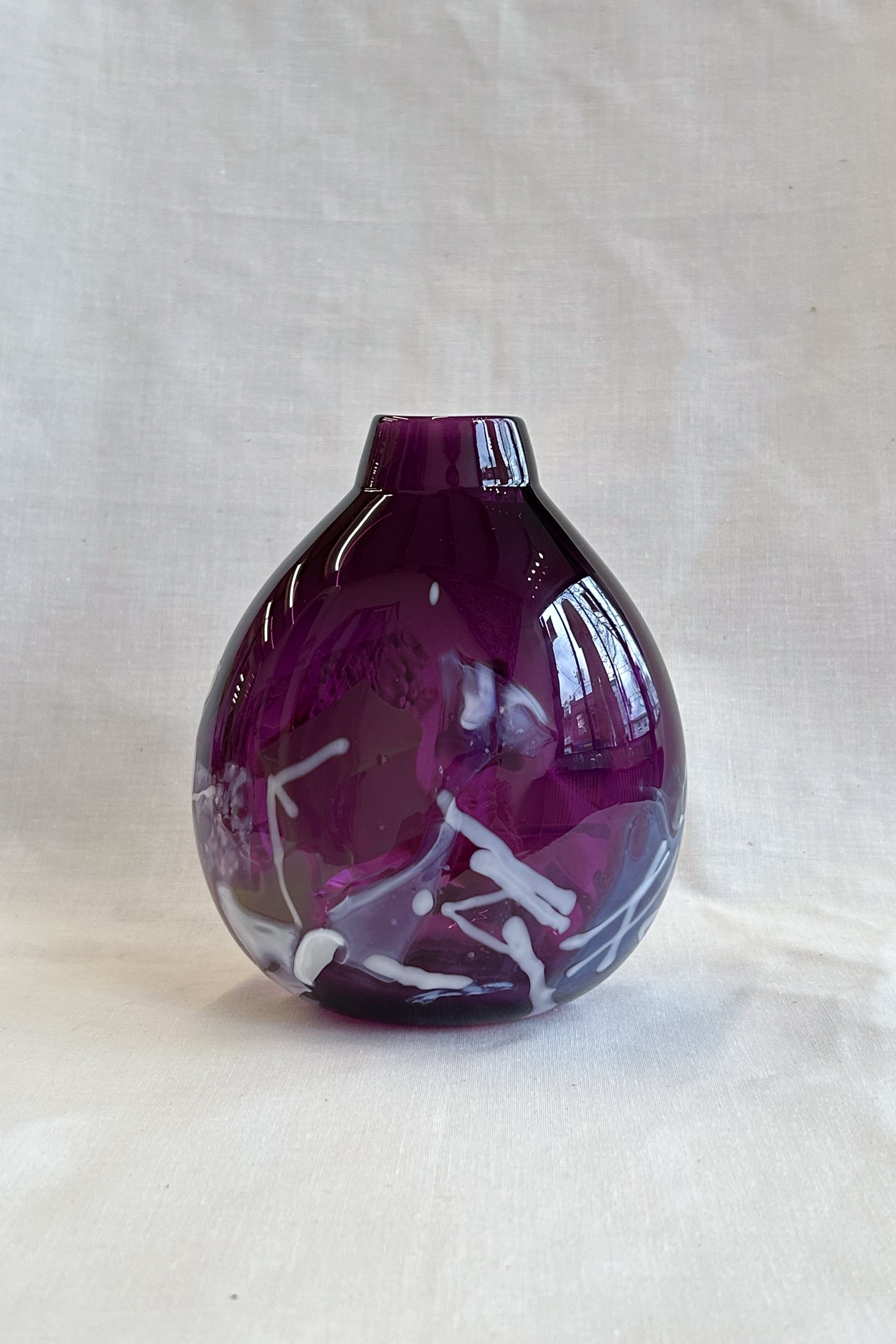 purple handblown glass vase with white patterns
