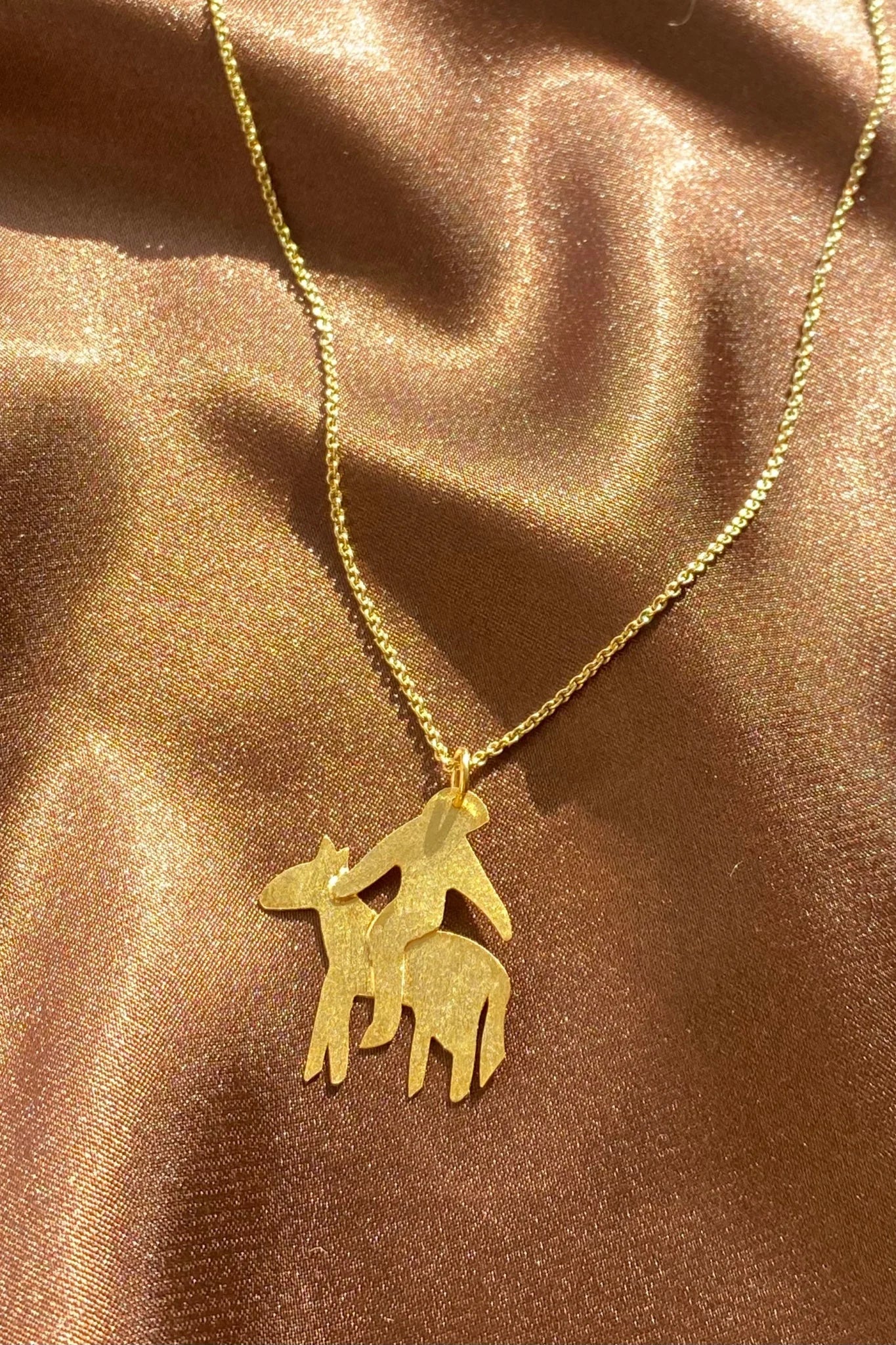 gold dainty horserider pendant on a thin chain