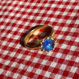 brass prong set ring with blue glass stone