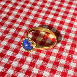 brass prong set ring with blue glass stone