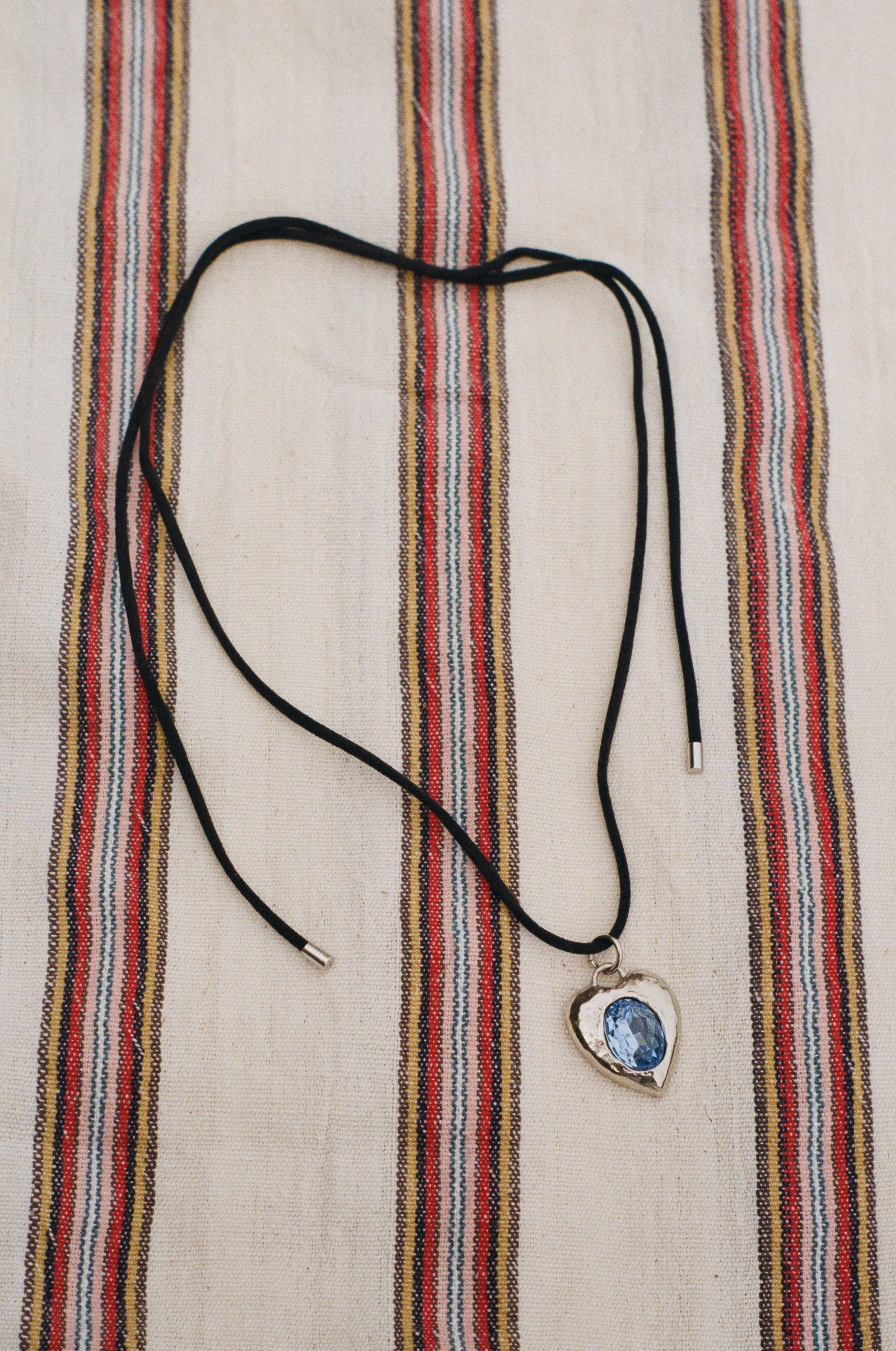 white bronze blue heart charm black cord necklace