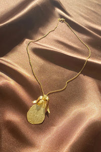 gold etched pear necklace on a dainty chain