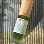 green bottled wooden topped cleanser moisturizer 
