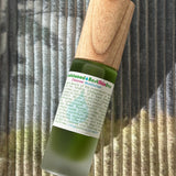 green bottled wooden topped cleanser moisturizer 