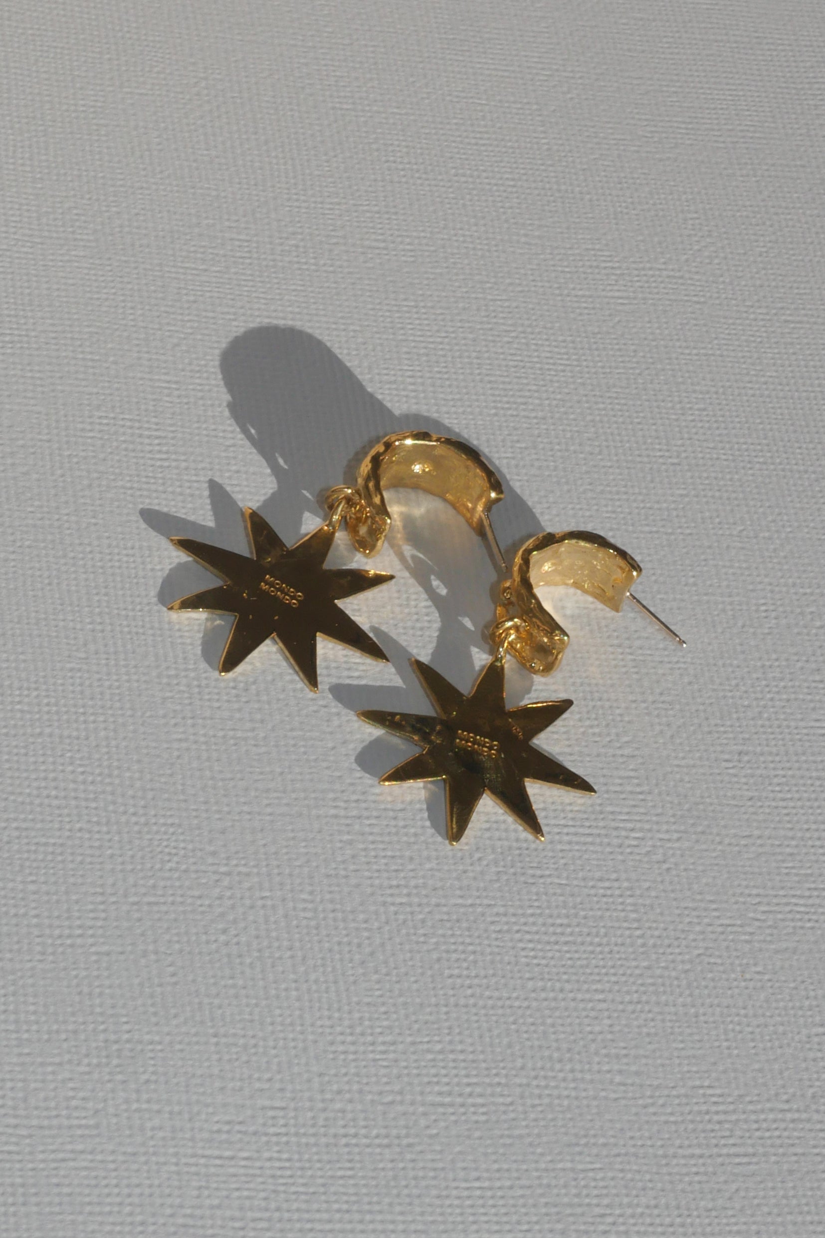 brass demi hoop earrings with dangling star