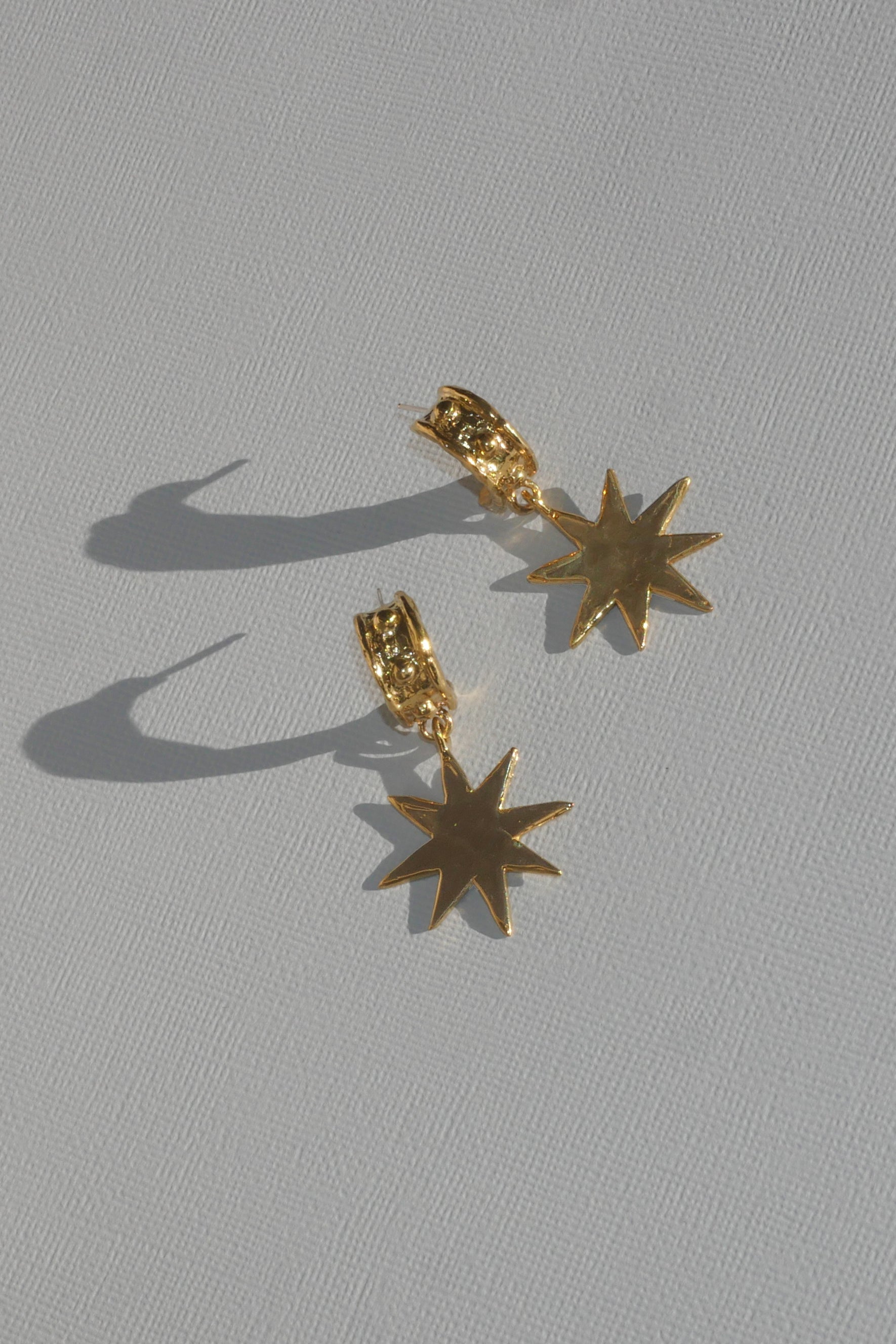 brass demi hoop earrings with dangling star