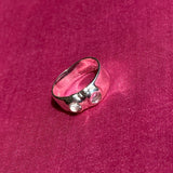 silver textured band ring with clear glass stones