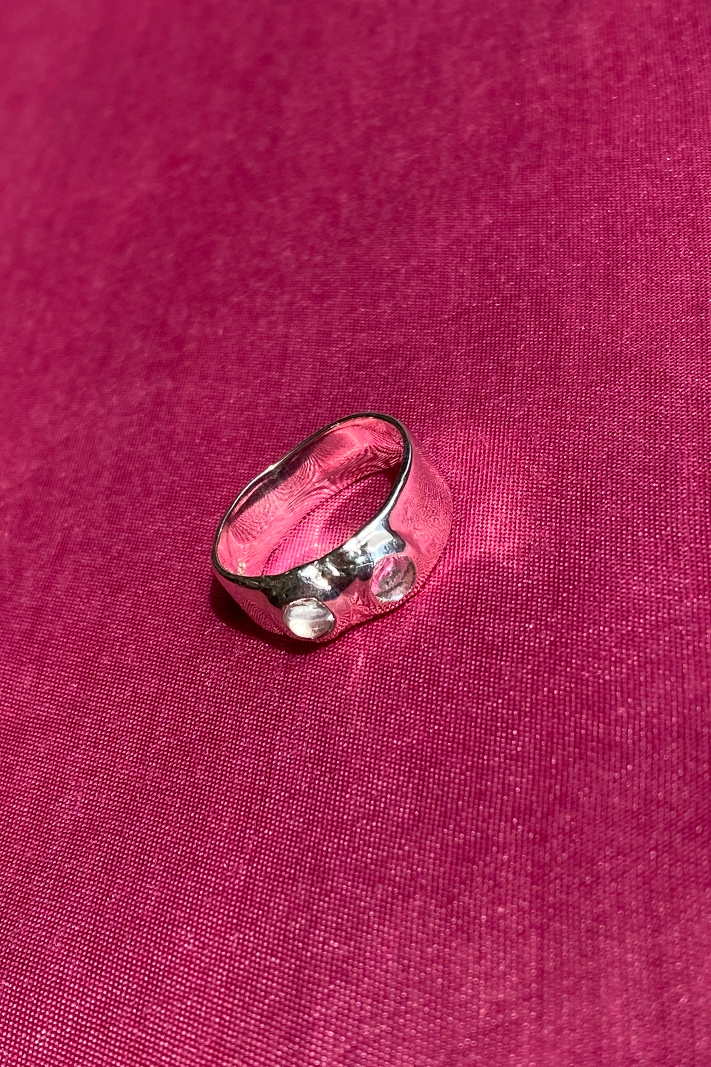 silver textured band ring with clear glass stones