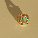 brass textured band ring with green stoned halo