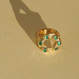 brass textured band ring with green stoned halo