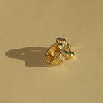 brass textured band ring with green stoned halo