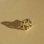 brass textured band ring with green stoned halo