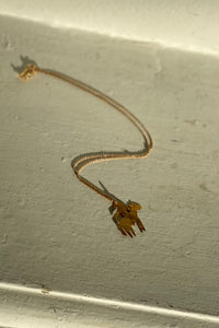 gold dainty horserider pendant on a thin chain