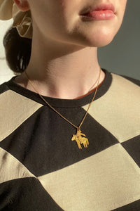 gold dainty horserider pendant on a thin chain