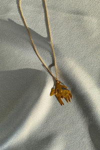 gold dainty horserider pendant on a thin chain