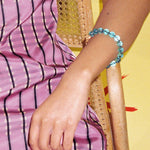 teal glass bead bracelet strung on silk thread