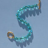 teal glass bead bracelet strung on silk thread