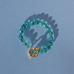 teal glass bead bracelet strung on silk thread
