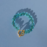 teal glass bead bracelet strung on silk thread