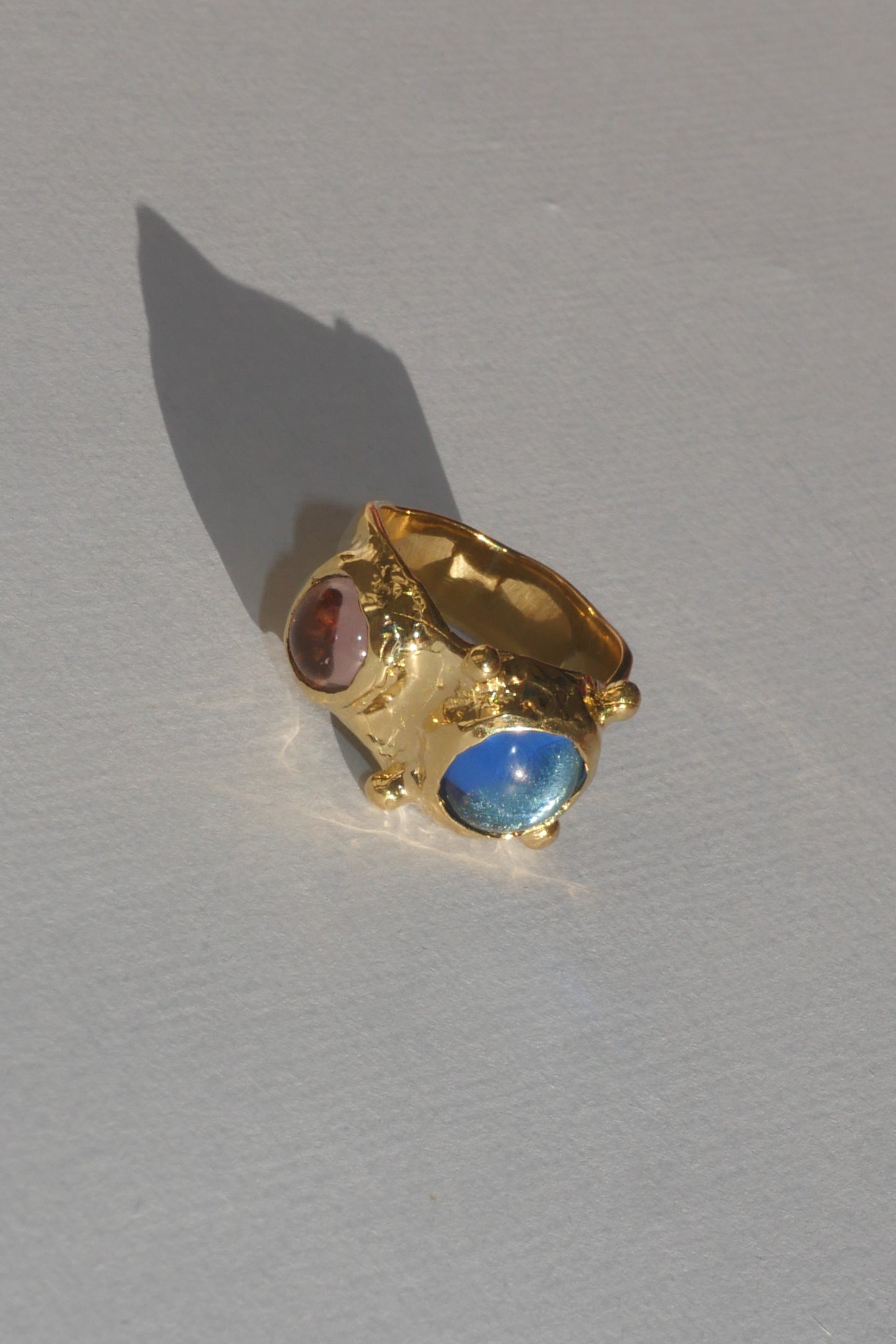 brass textured ring with blue and lavender cabochons