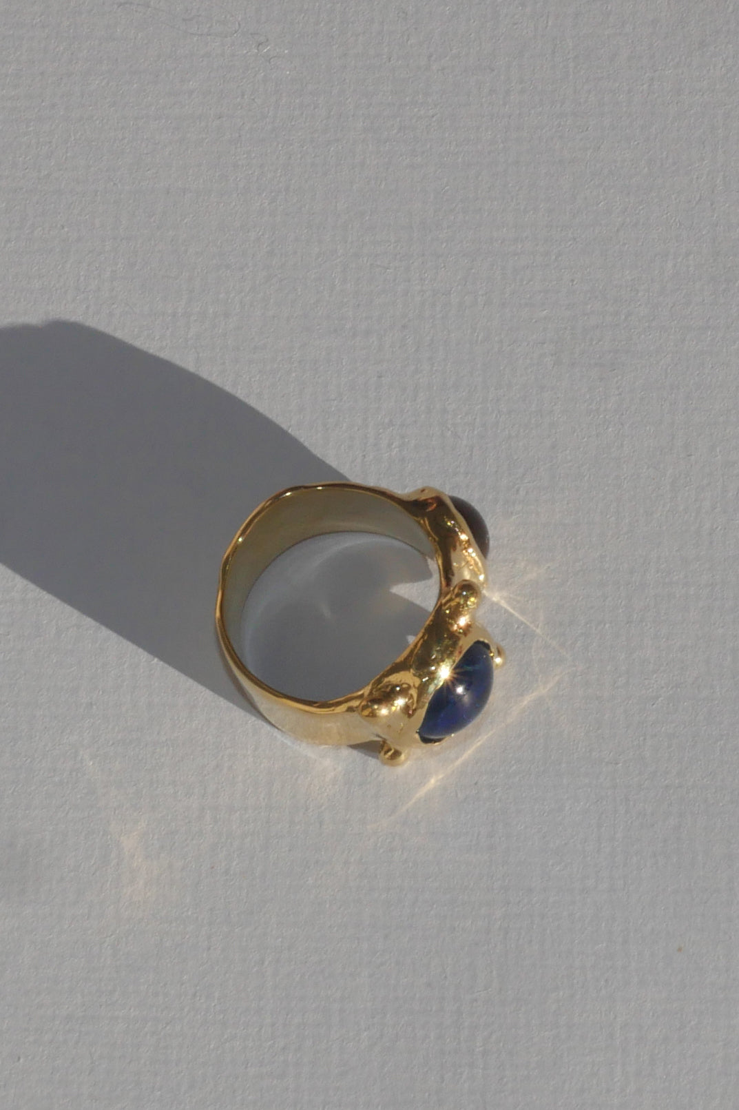 brass textured ring with blue and lavender cabochons