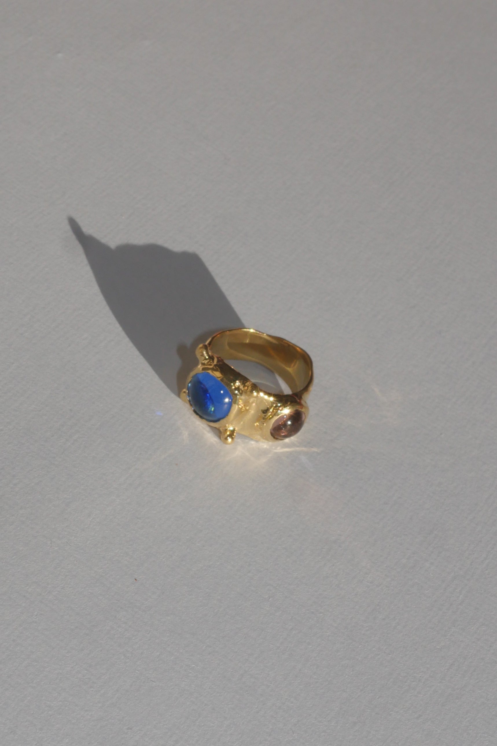 brass textured ring with blue and lavender cabochons