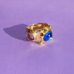 brass textured ring with blue and lavender cabochons