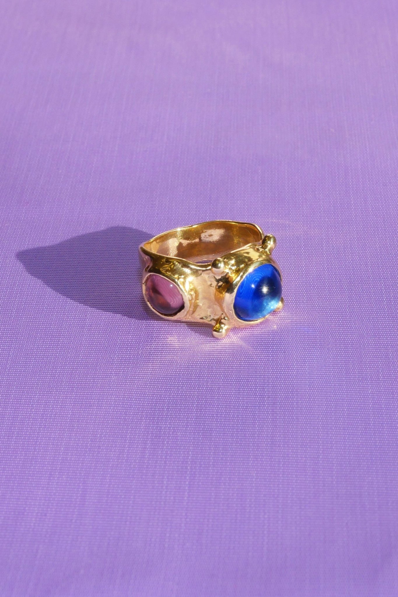 brass textured ring with blue and lavender cabochons
